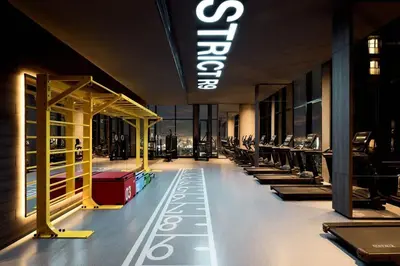 a gym with rows of exercise equipment in a building at Spacious 2 Bedrooms at MRT Rama 9 and Central R9 in Bangkok