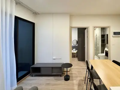 a living room with a table and a dining room at Spacious 2 Bedrooms at MRT Rama 9 and Central R9 in Bangkok