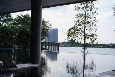 a tree is sitting in the middle of a body of water at The Politan Aqua in Ban Sai Ma