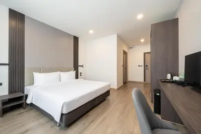 a hotel room with a bed and a tv at SureStay Plus by Best Western Ramkhamhaeng Airport Rail Link Bangkok in Bangkok