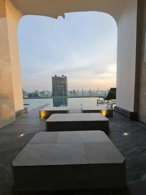 a building with two tables and a view of the city at New Ultra Highend Condo center BKK BTS 4min walk Perfect for Staycation in Bangkok