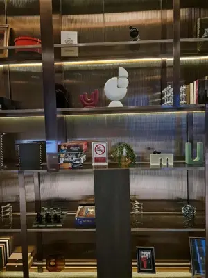 a shelf with many different items on it at New Ultra Highend Condo center BKK BTS 4min walk Perfect for Staycation in Bangkok