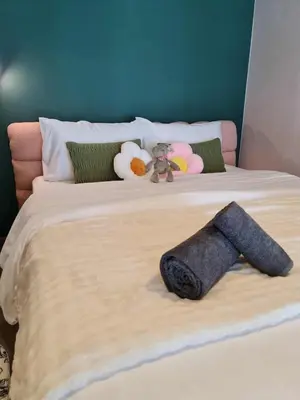 a bed with a towel on it with stuffed animals on it at New Ultra Highend Condo center BKK BTS 4min walk Perfect for Staycation in Bangkok