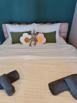 a bed with two stuffed animals on top of it at New Ultra Highend Condo center BKK BTS 4min walk Perfect for Staycation in Bangkok