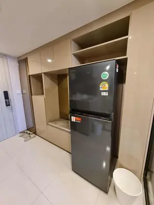 a small kitchen with a refrigerator in a room at New Ultra Highend Condo center BKK BTS 4min walk Perfect for Staycation in Bangkok