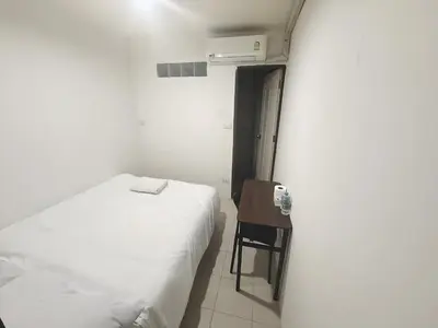 a bedroom with a white bed and a table at xx zNap Khaosan - แสนป ข้าวสาร รามบุตรี in Bang Bua Thong Railway Station