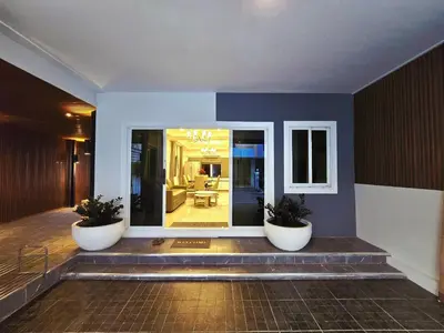 a lobby with two large white pots on the stairs at The Atlas hostel Bangkok in Thung Si Kan