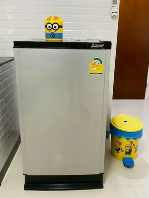 a refrigerator with a box on top of it next to a bucket at Pixie Happy Room Popular Condo C5 Cozy Private Room near IMPACT Muangthong in Ban Bang Phang