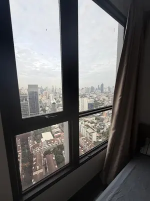 a view of a city from a bedroom window at Private Skyrise view on thonglor in Bangkok