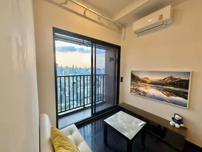 a living room with a large window with a view at Private Skyrise view on thonglor in Bangkok