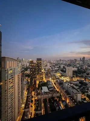 a view of a city at night with buildings at Private Skyrise view on thonglor in Bangkok