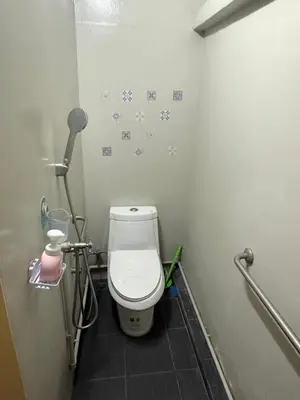 a small bathroom with a toilet in a stall at Muzachi home stay and canal in Bangkok Yai