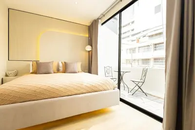 a bedroom with a bed and a large window at 2 Bedrooms 4 guests Private Floor at Sathorn in Bangkok