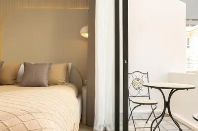 a bedroom with a bed and a table and a window at 2 Bedrooms 4 guests Private Floor at Sathorn in Bangkok