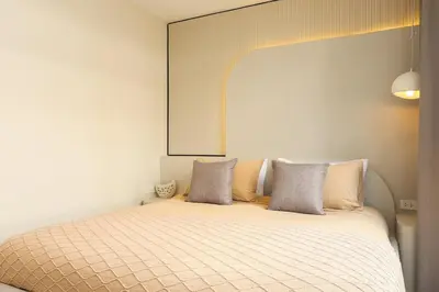 a bed with two pillows on top of it at 2 Bedrooms 4 guests Private Floor at Sathorn in Bangkok