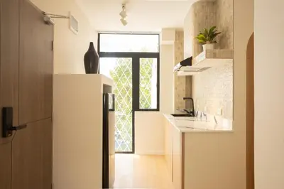 a kitchen with a sink and a door with a window at 2 Bedroom for 4 Guests Private at Center Sathorn in Bangkok