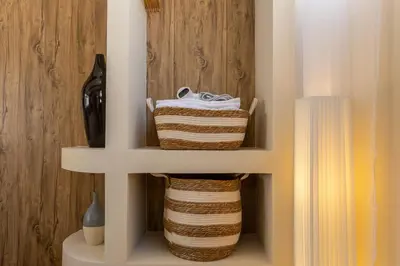 a shelf with two baskets in a room at Studio for 3 Guests with Kitchen at Center Sathorn in Bangkok