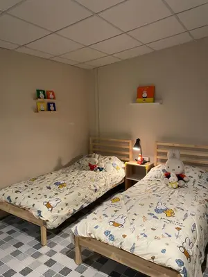a bedroom with two twin beds and a stuffed animal on the bed at mug & bed in Bangkok
