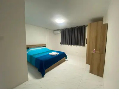 a bedroom with a blue bed with towels on it at PN Apartment At Udomsuk 47