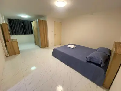 a bedroom with a blue bed in the middle of it at PN Apartment At Udomsuk 47