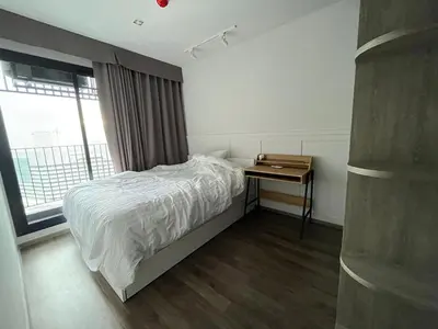 a bedroom with a bed and a desk with a window at 35sqm comfy condo near JJ Market in Bangkok