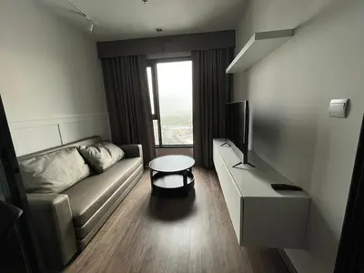 a living room with a couch and a television at 35sqm comfy condo near JJ Market in Bangkok