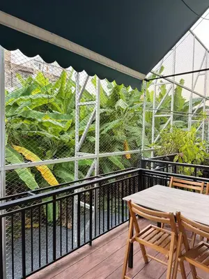 a balcony with a table and chairs and plants at Bonvie Residence in Thung Maha Mek