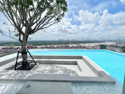 a pool with a tree on top of a building at New Luxury Condo 5 Min Onnut BTS - Modiz Sukhumvit 50 in Bangkok