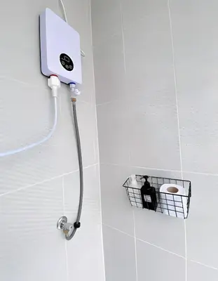 a shower in a bathroom with a person in a basket at xx GO INN MRT Hua Lamphong - วัดไตรมิตร in Samphanthawong