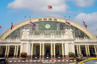 a large building with flags on top of it at xx GO INN MRT Hua Lamphong - วัดไตรมิตร in Samphanthawong