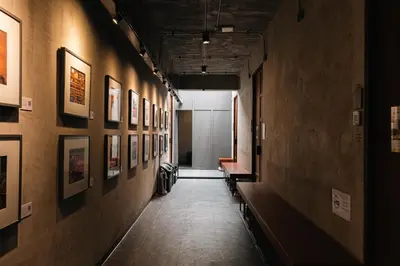 a hallway with benches and pictures on the walls at Once Again Hostel in Bangkok