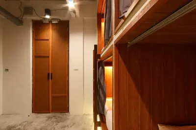 a room with a hallway with a door and a bedroom at Once Again Hostel in Bangkok