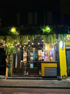 a restaurant on a street at night at Lesbase Female 8-Bed Room in Bangkok