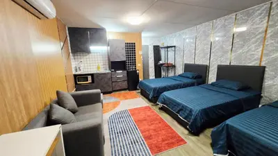 a living room with two beds and a couch at อิมแพ็ค เมืองทองธานี ห้องเช่ารายวัน เมืองทอง คอนโดเมืองทอง c9