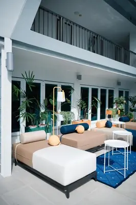 a living room with couches and tables at Le Tada Parkview Hotel in Bangkok