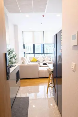 a living room with a couch and a table at Luxury 1 Bedroom l BTS 2 mins l Pool and Gym in Pratunam