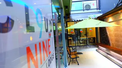 a yellow umbrella sitting in front of a restaurant at Cloud 9 Lodge in Bangkok