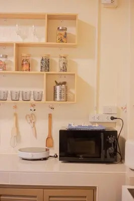 a kitchen with a microwave on a counter at Warm & Cozy Family Home, Near BTS Punnawithi in Phra Khanong