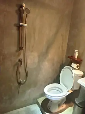 a bathroom with a shower with a toilet and a sink at Bangkok Phattanakan32 guest house in Bangkok