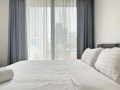 a bedroom with a white bed and a large window at City life Nana - near Bumrungrad Hospital in Bangkok