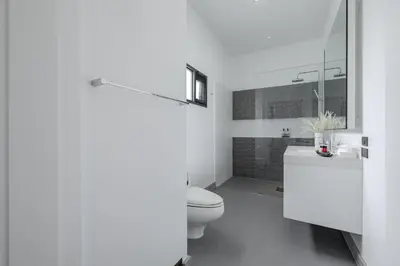 a white bathroom with a toilet and a sink at Thong Lo Luxury Pool Villa In Center Of Bangkok in Bangkok