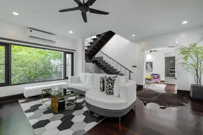 a living room with a white couch and a table at Thong Lo Luxury Pool Villa In Center Of Bangkok in Bangkok