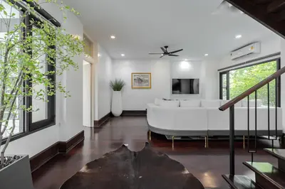 a living room with a large white couch at Thong Lo Luxury Pool Villa In Center Of Bangkok in Bangkok