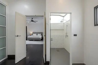 a hallway with a door leading to a bedroom at Thong Lo Sumptuous Double Pool Villa in Bangkok