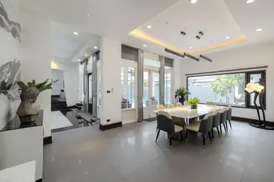 a dining room with a table and chairs at Thong Lo Sumptuous Double Pool Villa in Bangkok
