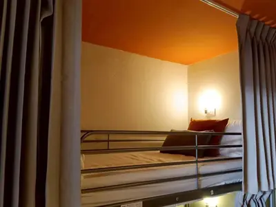 a bedroom with a bunk bed with a window at Nitra Hostel Siriraj in Bangkok
