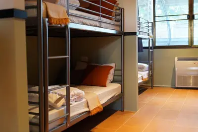 a bunk bed room with a bunk bed in a room at Nitra Hostel Siriraj in Bangkok