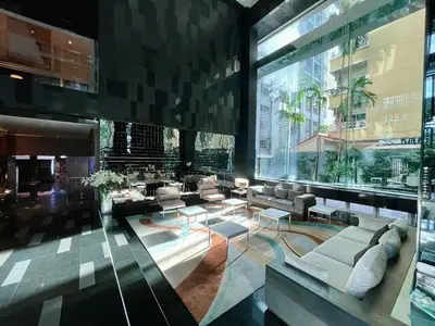 a lobby with couches and tables in a building at Supreme Spacious 2-Bedroom in Prime Location! BTS Thonglor in Bangkok
