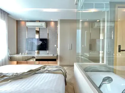 a bathroom with a tub and a bed and a television at Supreme Spacious 2-Bedroom in Prime Location! BTS Thonglor in Bangkok