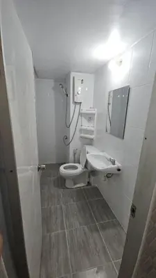 a bathroom with a toilet and a sink at Hi Impact Muangthong T9 in Nonthaburi